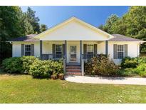 Charming home featuring a cozy front porch with lovely landscaping at 4030 Orion Rd, York, SC 29745