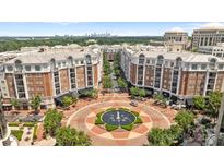 Aerial view of building with fountain in a circular driveway with trees and Charlotte, NC skyline in background at 4625 Piedmont Row Dr, Charlotte, NC 28210