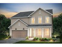 Traditional two-story home with beige siding, a brick-based porch, and an attached two-car garage at 5240 Hatcher Creek Rd # 51, Charlotte, NC 28215