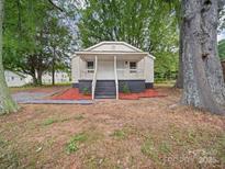 Charming single-story home featuring a cozy front porch and newly landscaped garden, creating a welcoming curb appeal at 821 1St St, Kings Mountain, NC 28086