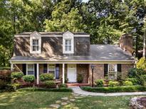 Charming brick home featuring dormer windows and well-manicured landscaping at 101 Treeline Dr, Belmont, NC 28012
