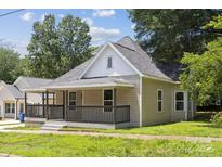 Charming home featuring a cozy front porch, neutral siding, and a well-maintained lawn at 1108 4Th St, Statesville, NC 28677