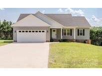 Charming single-story home with gray siding, white trim, and a spacious two-car garage at 118 Cypress Acres Ln, Statesville, NC 28625
