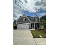 Beautiful two-story home with a two-car garage and well-maintained landscaping at 1411 Cottage Green Dr # 218, Monroe, NC 28112