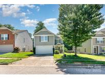 Charming two-story home with attached garage and well-manicured lawn in a suburban neighborhood at 1432 Matthew Allen Cir, Kannapolis, NC 28081