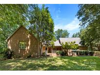 Charming brick home featuring a well-maintained lawn and mature trees at 1505 N Cansler St, Kings Mountain, NC 28086