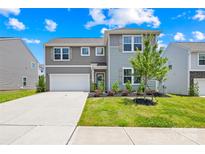 Charming two-story home featuring a well-manicured lawn, attached garage, and welcoming front entrance at 2512 Andes Dr, Statesville, NC 28625
