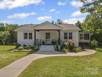 Charming single-story home featuring a well-manicured lawn and welcoming front porch at 4615 Lockhart Rd, Sharon, SC 29742