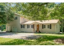 Charming two-story home with a metal roof, black shutters, and mature trees offering plenty of shade at 4919 Rehobeth Rd, Waxhaw, NC 28173