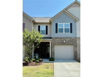 Charming two-story townhome with brick accents, a single-car garage, and a well-manicured front lawn at 5236 Spanish Ivy Ln, Indian Land, SC 29707