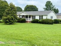 Charming single-story home with a well-manicured lawn and inviting front porch at 5816 Scotland Yard Rd, Rock Hill, SC 29732