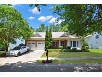 Charming brick home with a well-manicured lawn, three-car garage, and appealing landscaping at 8712 Soaring Eagle Ln, Waxhaw, NC 28173