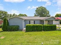 Charming single-story home with a well-manicured lawn and lush green shrubbery at 151 Robinson Rd, Gastonia, NC 28056