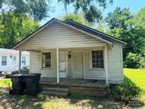 A small, one-story home with a weathered facade and a porch, surrounded by trees at 213 Maple St, Rock Hill, SC 29730