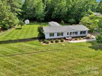 Charming single-story home with meticulously maintained landscaping and a fenced backyard at 329 W Red Cross Rd, Oakboro, NC 28129