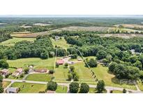 Beautiful property featuring a large lot with wooded areas and outbuildings, providing both privacy and functionality at 3724 County Home Rd, Conover, NC 28613