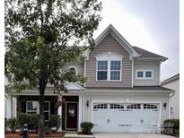 Charming two-story home featuring a two-car garage, landscaped front yard, and inviting entrance at 1307 Farm Branch Sw Dr, Concord, NC 28027
