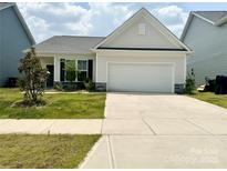 Charming single-Gathering home boasts a two-car garage, manicured lawn, and stylish exterior at 211 Surrey Oak Ln, Charlotte, NC 28216