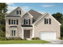 Charming two-story brick home with stone accents, black shutters, and an attached two-car garage at 3026 Tramore Dr, Harrisburg, NC 28075