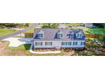 Charming home with well-manicured lawn, driveway, and inviting curb appeal at 7039 Executive Cir, Denver, NC 28037