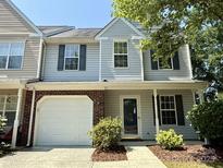 Charming two-story townhouse featuring a one-car garage and welcoming front entrance at 9730 Elizabeth Townes Ln, Charlotte, NC 28277