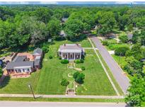 Stunning aerial view of a stately home with lush green lawn and mature trees, plus outbuilding at 15 Kings Mountain St, York, SC 29745