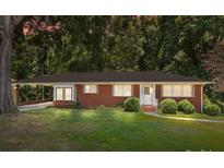 Charming one-story brick home featuring a well-maintained lawn and cozy covered parking at 207 W 21St St, Kannapolis, NC 28081