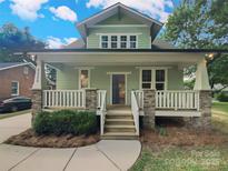Charming two-story home with a welcoming front porch and stone accents at 2222 Camp Greene St, Charlotte, NC 28208