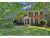 Beautiful two-story brick home with manicured lawn and mature trees at 2358 Sparrow Dr, Rock Hill, SC 29732