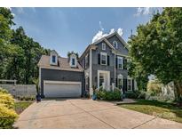 Charming two-story home with a well-maintained lawn, beautiful landscaping, and a two-car garage at 2936 Saintfield Pl, Charlotte, NC 28270