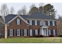 Charming two-story brick home with black shutters and a well-manicured front lawn at 3015 Rochester Ct, Monroe, NC 28110