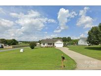 Charming single-story home with a long driveway, spacious front yard, and a covered front porch at 3810 Spike Ln, Vale, NC 28168