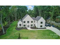 Stunning white modern home surrounded by lush greenery and landscaping at 4208 Antioch Church Rd # 1, Weddington, NC 28104