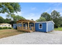 Charming blue home with a covered porch and gravel driveway at 4351 Saluda Rd, Rock Hill, SC 29730