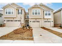 Inviting townhome with a one car garage and well-manicured front yard and concrete driveway at 7217 Hodges Meadow Ln, Charlotte, NC 28213