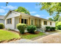 Charming single story home featuring wood post accents, classic shutters, and manicured landscaping at 80 Sumner Nw Ave, Concord, NC 28027