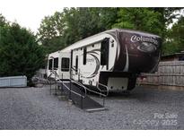 A large, modern Columbus RV with a ramp sits on a gravel lot at 114 Redwood Trl, Mount Gilead, NC 27306