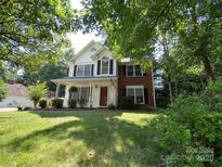 Charming two-story home with a welcoming front porch and well-maintained lawn at 12623 Levins Hall Rd, Huntersville, NC 28078