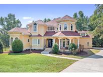 Elegant two-story home boasting a charming facade, manicured lawn and symmetrical design at 149 Vista Bluff Ln, Mooresville, NC 28117