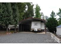 The charming RV with cover offers convenient parking and protection from the elements at 155 Holly Harbor Trl, Mount Gilead, NC 27306