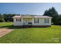 Charming single-story home with a well-maintained lawn and inviting front porch at 2694 Rock Dam Rd, Lincolnton, NC 28092