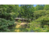 Wood home surrounded by trees featuring green grass and a front porch at 5212 Timber Creek Ct, Kings Mountain, NC 28086