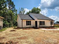 Charming single-story home featuring a well-manicured lawn, neutral siding, and dark shutters at 723 Taylor St, Rock Hill, SC 29730