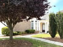 Charming home exterior with a well-manicured lawn, a welcoming entrance, and mature trees in the front yard at 7406 Carolina Jessamine Ct, Indian Land, SC 29707