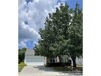 Charming home featuring a two-car garage, lovely landscaping, and a traditional design at 9313 Arcola Ln, Charlotte, NC 28277