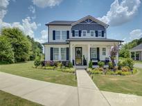 Charming two-story home with landscaped front yard and welcoming front porch at 9507 Pointer Rd, Huntersville, NC 28078