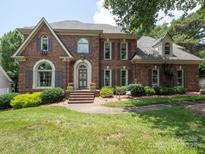 Charming brick home featuring well-manicured landscaping and a welcoming front entrance at 10500 Kilmory Ter, Charlotte, NC 28210
