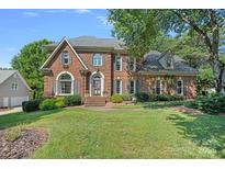Beautiful brick home with a manicured lawn and mature trees in a desirable neighborhood at 10500 Kilmory Ter, Charlotte, NC 28210
