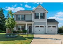 Charming two-story home featuring gray siding, a two-car garage, and a well-manicured lawn at 210 Clove Hitch Dr, Statesville, NC 28677