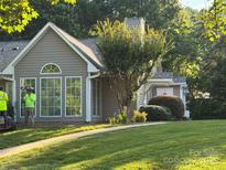 Charming home featuring large windows and a well-maintained lawn at 21120 Cold Spring Ln, Cornelius, NC 28031